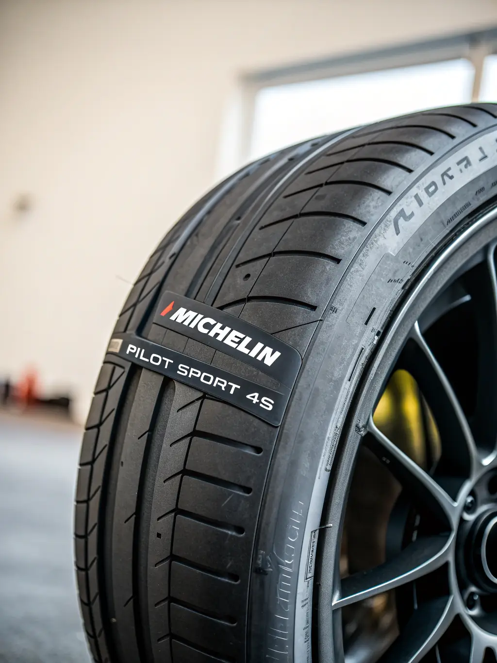 A close-up shot of a high-performance motorcycle tire, showcasing its tread pattern and sidewall details, in the context of a tire buying guide for Motor Guide.